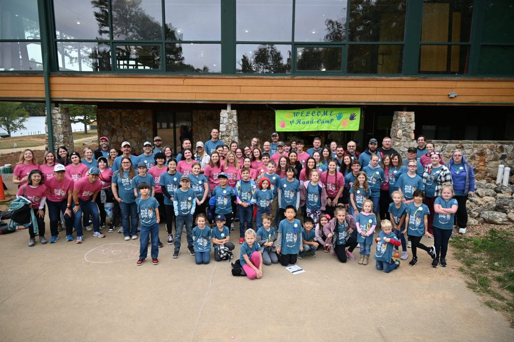 The entire hand camp group: kids, families, and counselors